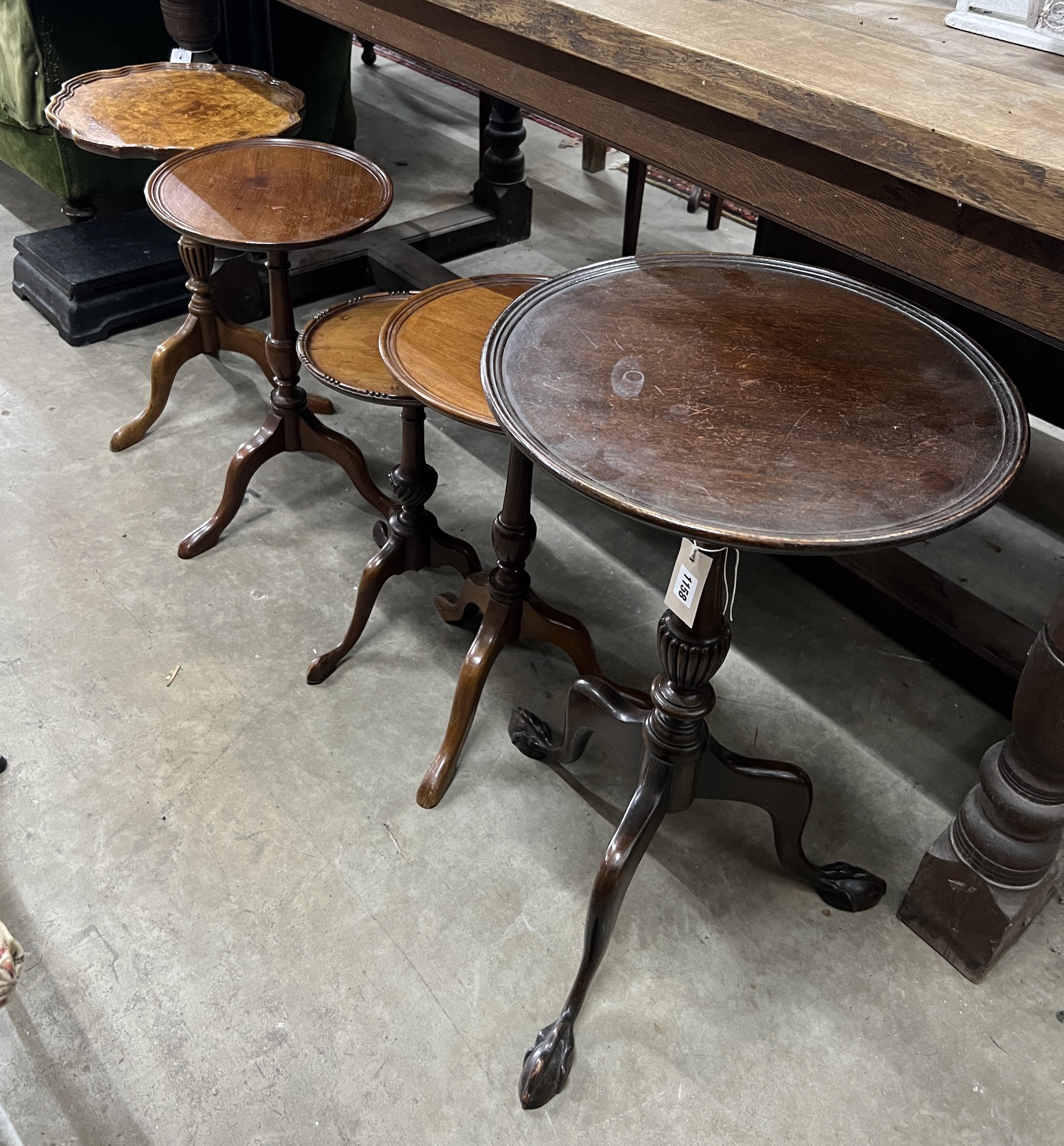 Five early 20th century and later circular mahogany and walnut tripod wine tables, largest diameter 37cm, height 63cm